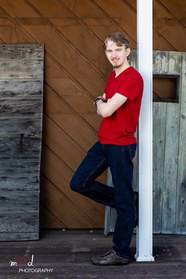 Andrew leaning against a wall